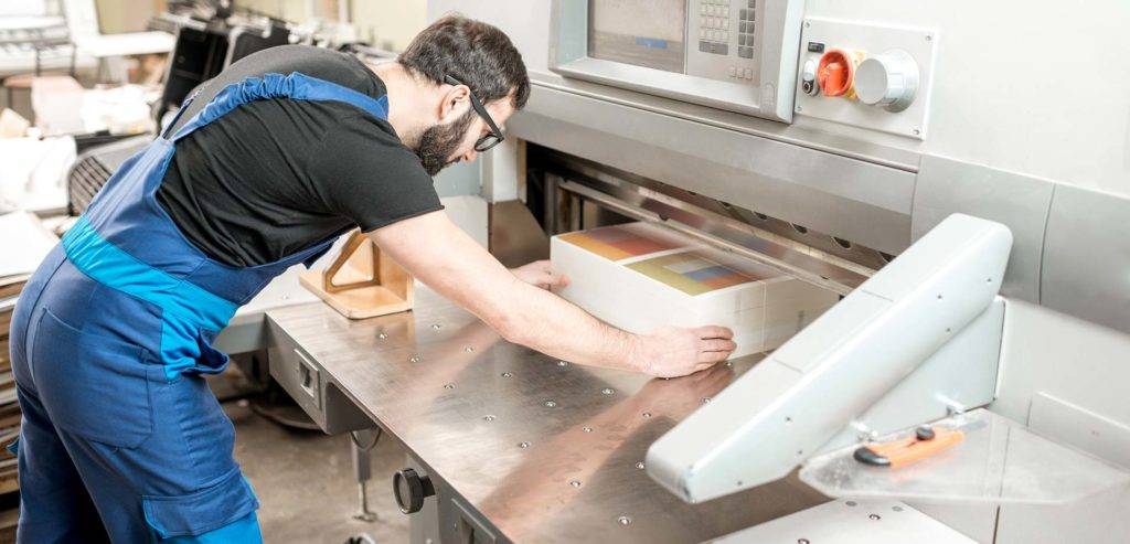 Man working on commercial printing press